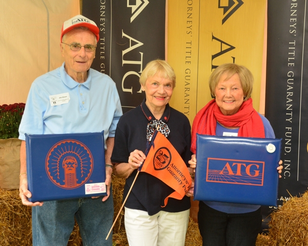 Displaying yesteryear’s ATG Illini Tailgate gear are Jim and Nancy Elson with Mary Satter at ATG 50th Tailgate